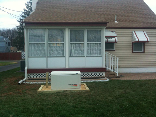 A standby generator installed alongside a residential sunroom.