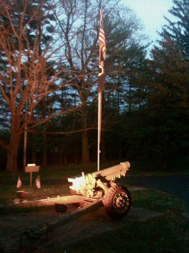 Exterior lighting around a flagpole and landscape feature.