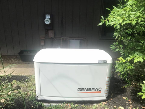 Generac standby generator beside a home
